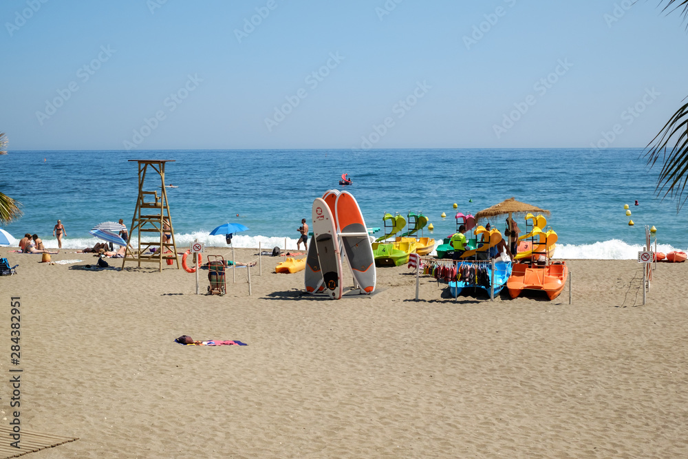 people at the beach with palm trees on the shore of the Mediterranean Sea