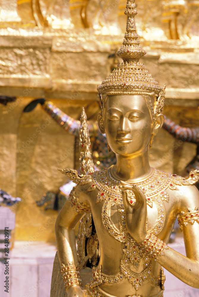 Thailand, Bangkok. Gold statue at Wat Phra Kaew Temple near Grand Palace.