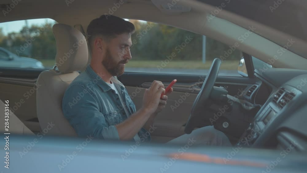 custom made wallpaper toronto digitalAttractive businessman texting in social network on smartphone sitting in modern car. Profile of handsome sociable guy with mobile phone planning a route through city.