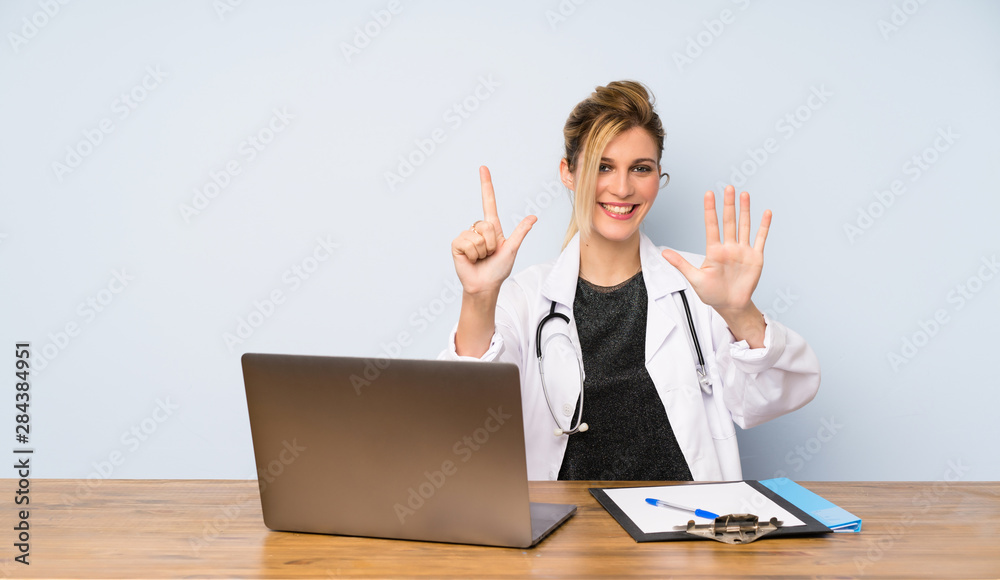 Blonde doctor woman counting seven with fingers Blonde doctor woman counting seven with fingers