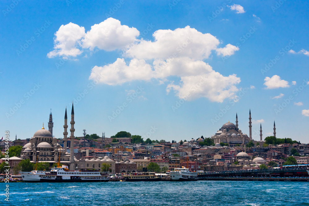 Fototapeta premium Yeni Cami (New Mosque) and other buildings along the waterfront. Golden Horn, Istanbul, Turkey.