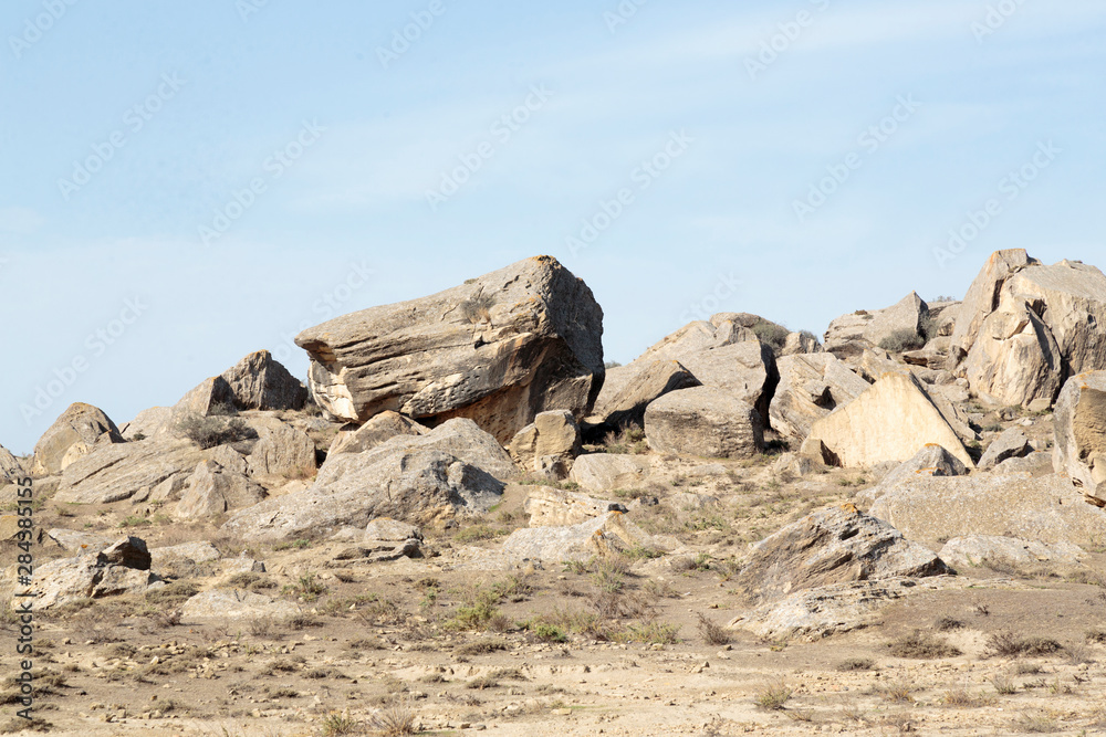 Azerbaijan, Qobustan. Large rocks scattered along the badlands of Qobustan.