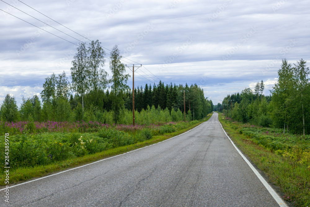 An empty road in Finland during a long evening