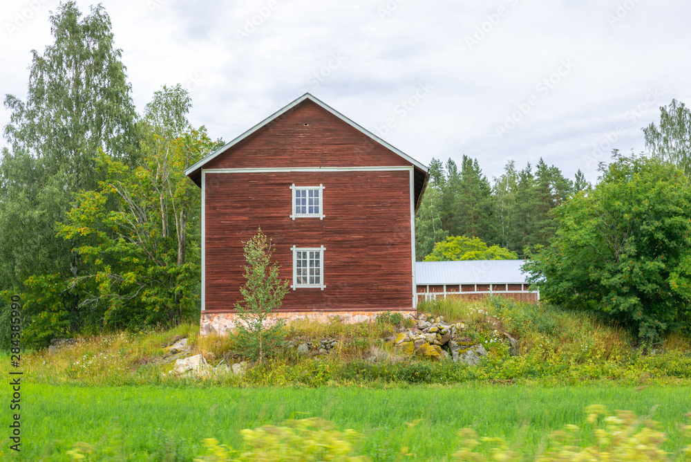 Fototapeta premium Traditional red nordic wooden stable in Finland during the day - 5