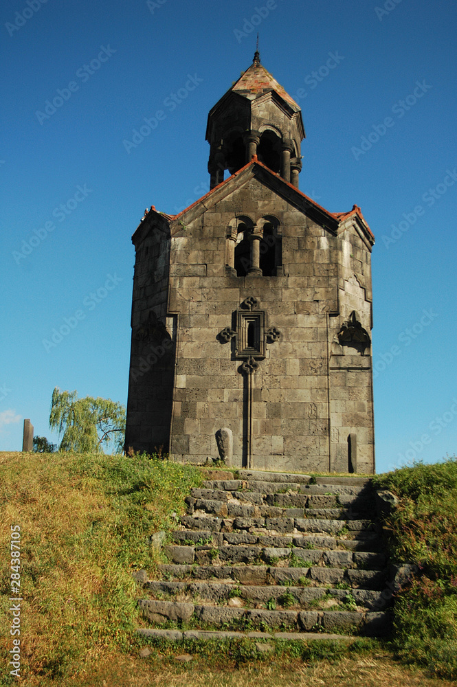 Armenia, Haghpat, view of a catholic church built with stones and a tiled roof, with a stone staircase in the foreground
