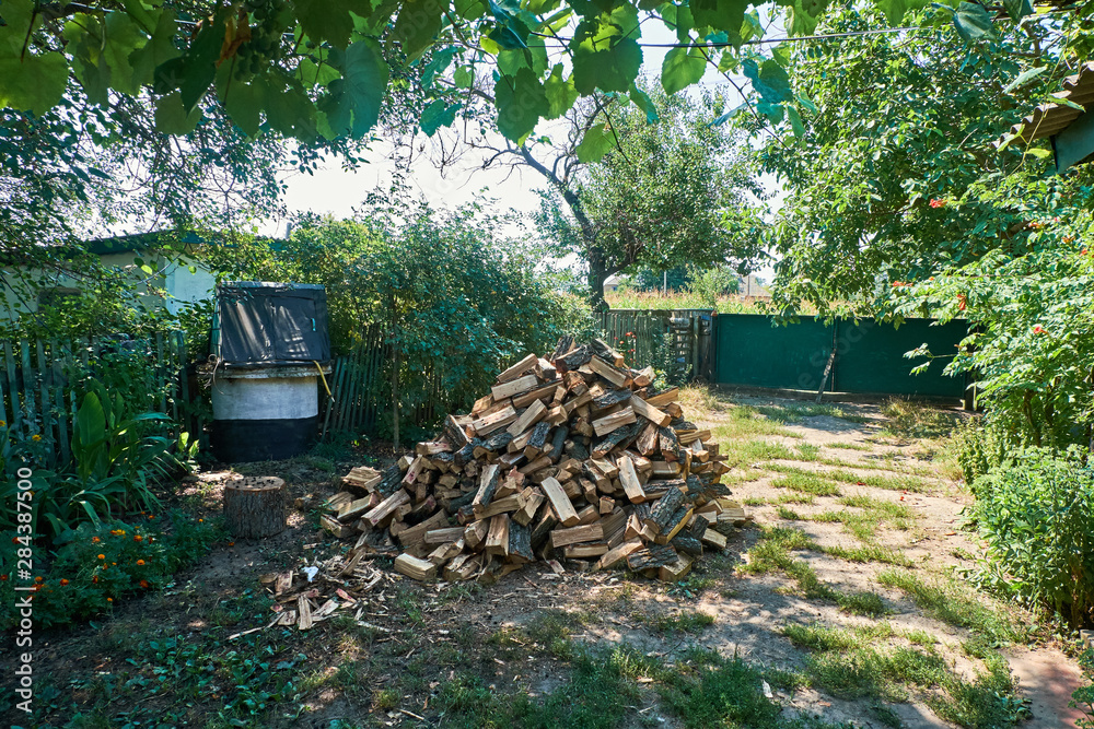 A stack of firewood in the yard