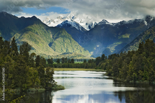 New Zealand, South Island. Cloud-shrouded Mt. Cook as seen from Lake Matheson near the town of Fox Glacier.  © Jaynes Gallery/Danita Delimont