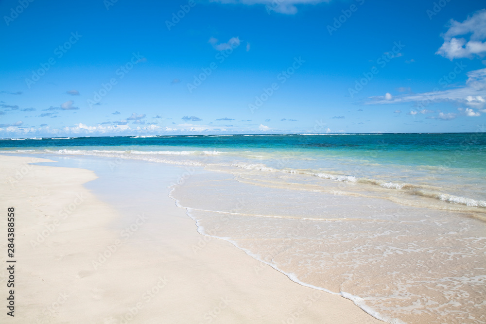 Vieques, Puerto Rico - Gentle waves are rolling up onto the white sands of a tropical beach.