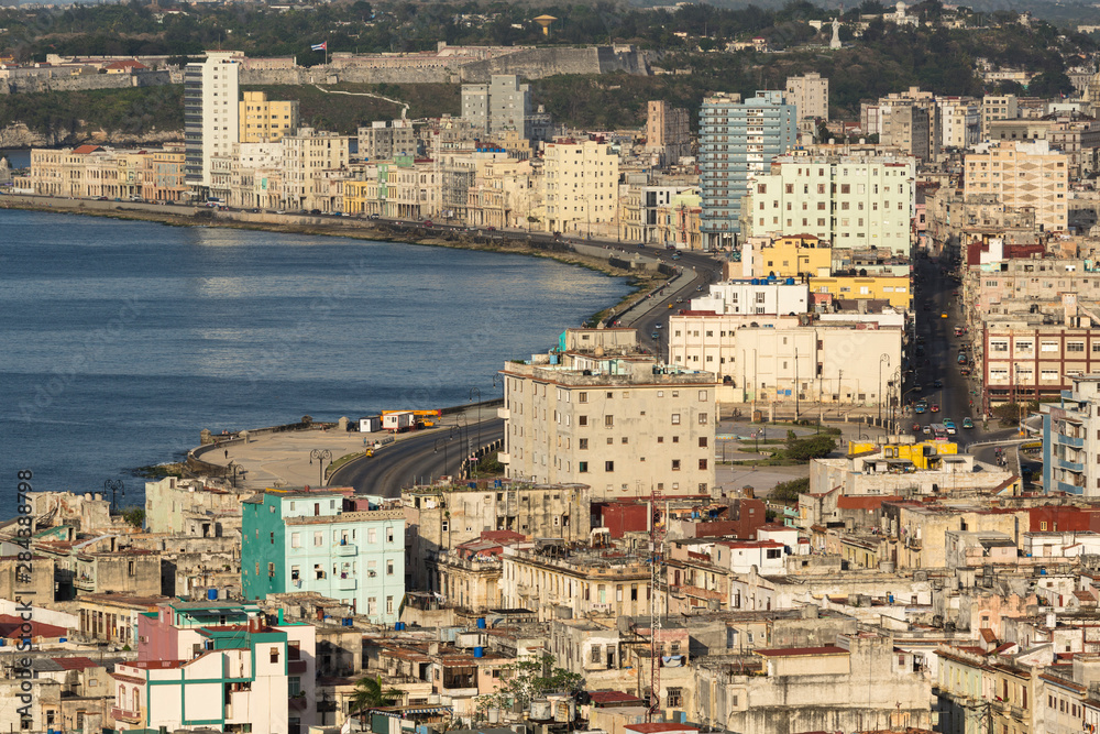 Cuba, Havana. An elevated view of the city skyline showing the bay and Malecon from a hotel rooftop.
