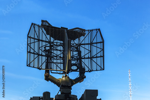 Radiolocating war machine. A target acquisition and distribution radar system. Radar of military machine under open sky. photo