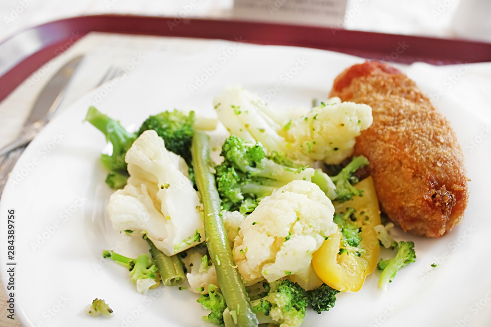 Lunch of the Kyiv cutlet, broccoli, cauliflower and asparagus on the white plate Lunch of the Kyiv cutlet, broccoli, cauliflower and asparagus on the white plate