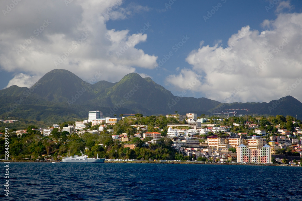 MARTINIQUE. French Antilles. West Indies. City of Fort-de-France below Pitons du Carbet & cumulus clouds.