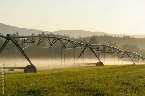 Canada, British Columbia, Vancouver Island, Cowichan Valley. Irrigation equipment water a field on a farm in the Cowichan Valley