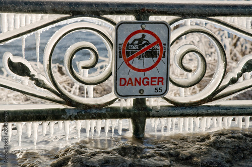 Canada, Ontario, Toronto, Niagara Falls. Icy rails above river with danger sign.