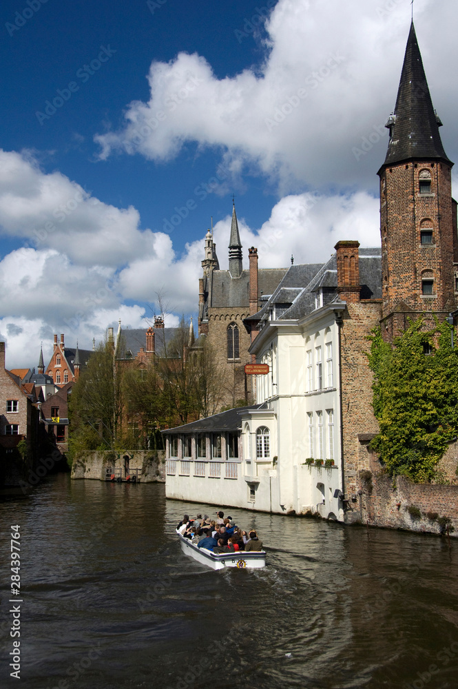 Belgium, Brugge (aka Brug or Bruge). Typical medieval architecture along the canals of Brugge, sightseeing cruise boat.