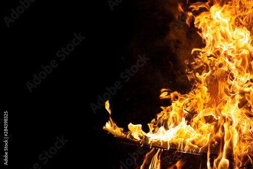 bright flame with the wood in the right areas of the image on a black background