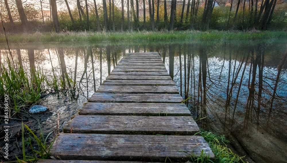 Fototapeta premium Wooden terrace surrounded by greenery
