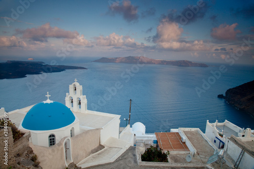 Greece, Santorini. Bell tower and blue domes of church in village of Firostefani