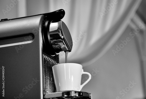 Espresso machine in action, filling a good cup of coffee.
