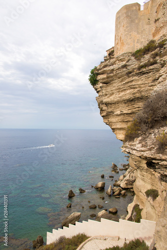 France, Corsica, Bonifacio. Limestone cliffs with fortress walls overhang Strait of Bonifacio