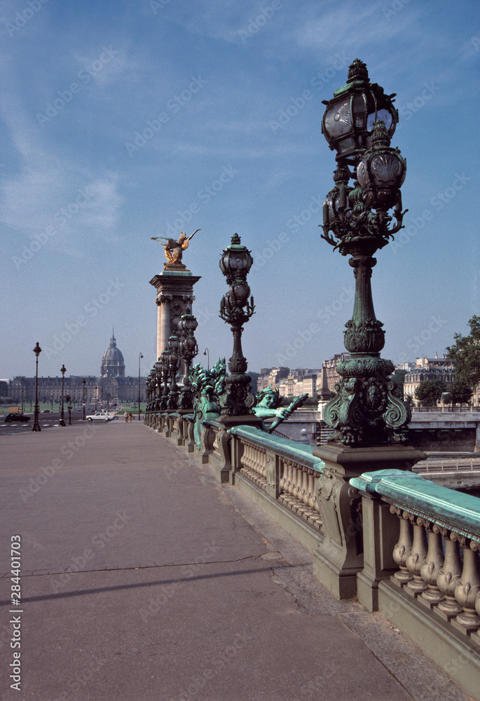 Fototapeta premium France, Paris. Art Nouveau lamp posts line Pont Alexandre III, part of a World Heritage Site, leading to the Dome Church and Invalides in Paris, France.