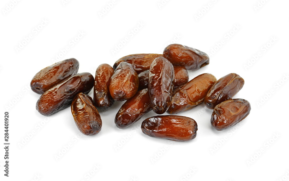Dried dates over white background. Heap of dried dates isolated on white background. Dried dates over white background. Heap of dried dates isolated on white background.
