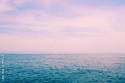 Beautiful blue sea and pink sky sunset background. © Inna