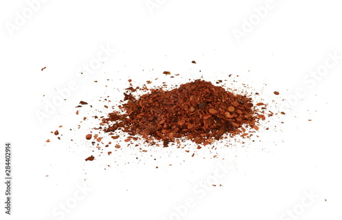 Cayenne pepper. Pile crushed red cayenne pepper, dried chili flakes and seeds isolated on white background