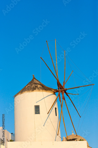 Windmill on the coast of Aegean Sea. Oia, Santorini Island, Greece.