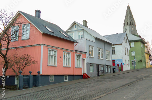 Fototapeta Naklejka Na Ścianę i Meble -  Iceland, Reykjavik. Church steeple and house-lined street.