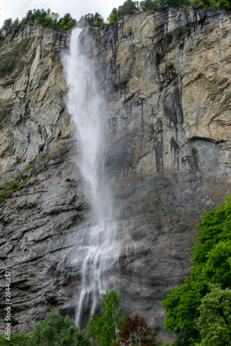 High waterfall (Staubbach) falling from the tall cliff, Lauterbrunnen Switzerland