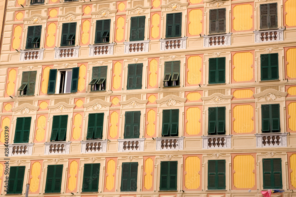 Italy, Camogli. Building painted in the trompe d'oeil or fool-the-eye style of decoration so that some windows are painted.
