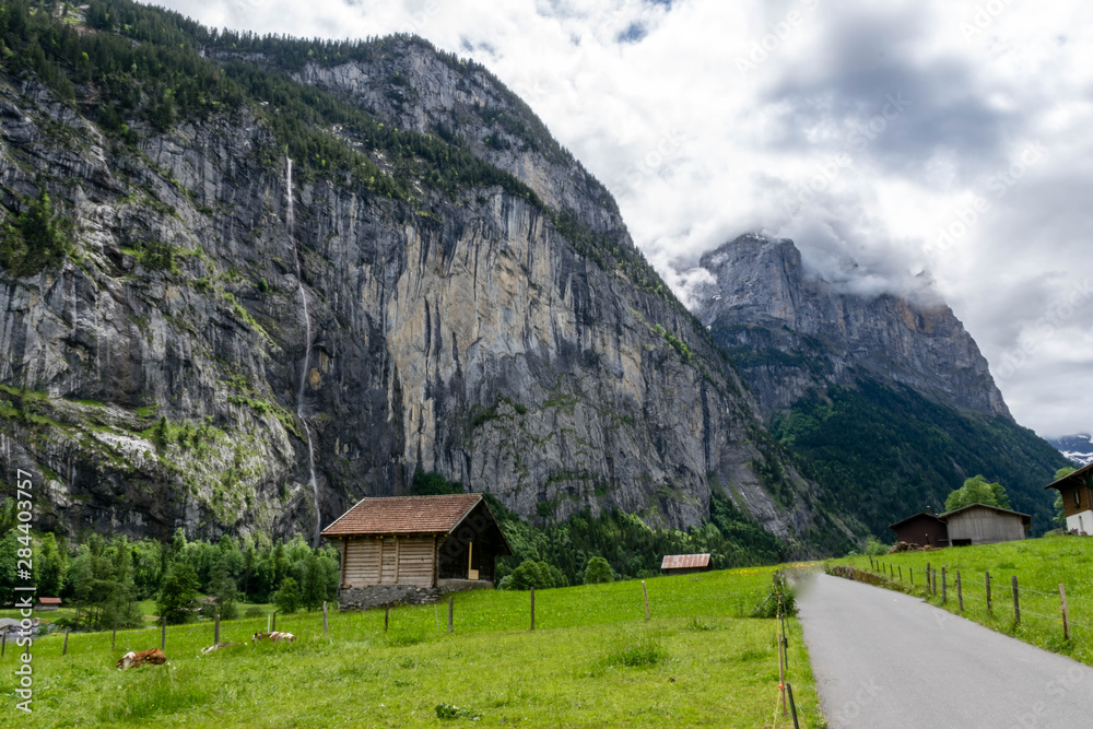 Walking road through waterfall valley, Switzerland