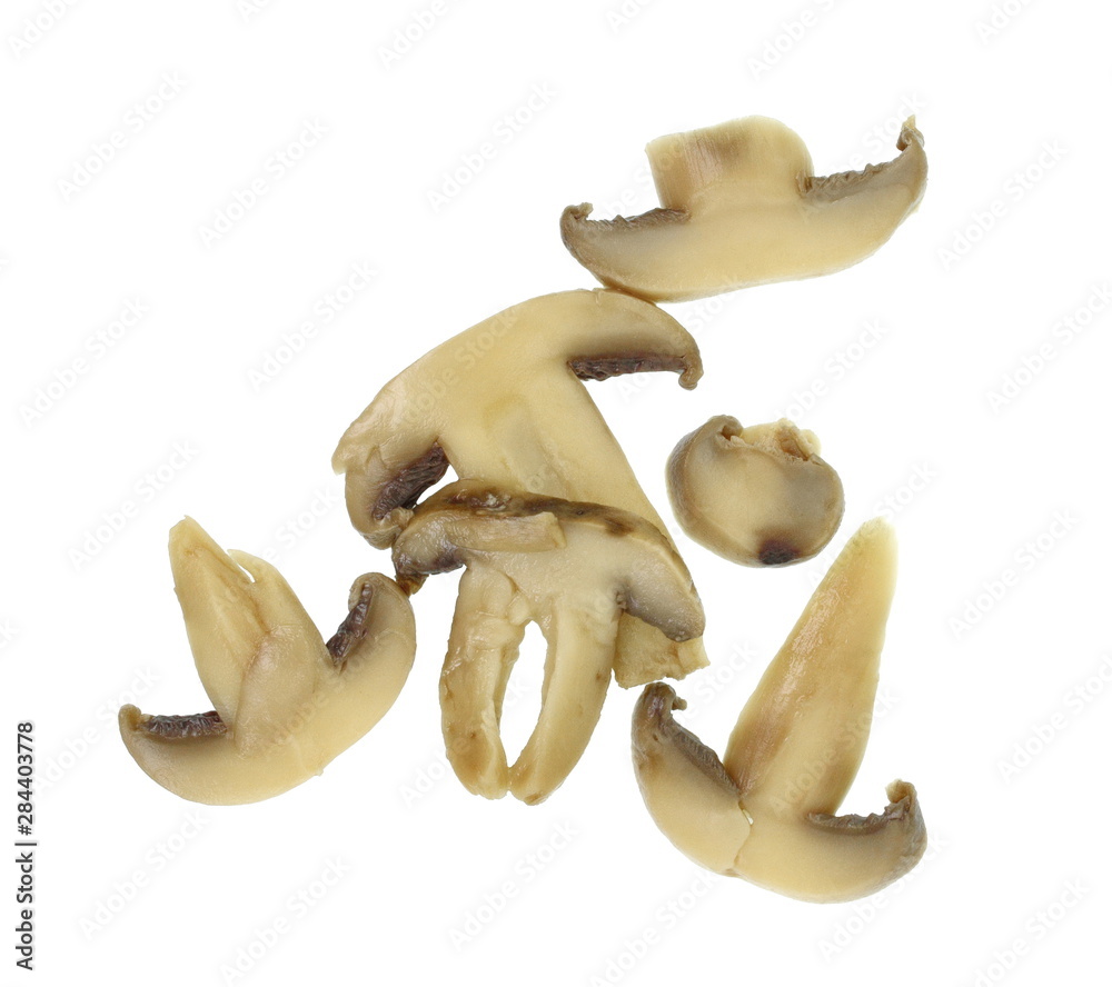 Fototapeta premium canned mushroom pieces on a white background.