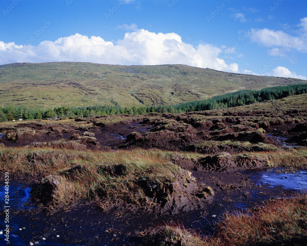 Ireland, Carrick. Clouds billow beyond the heathery peat bogs of Carrick, County Donegal, Ireland.