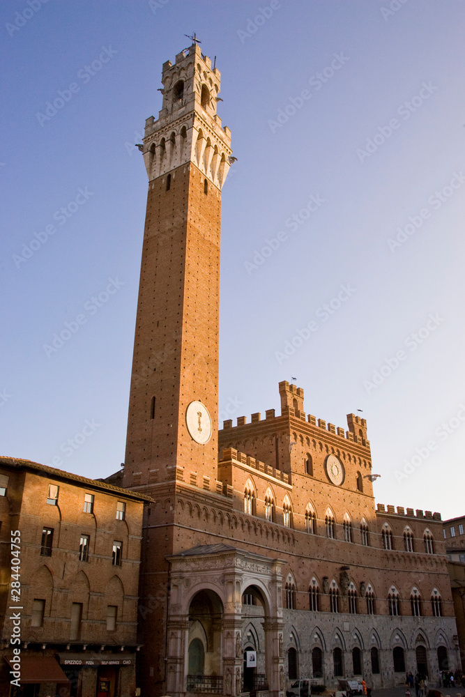 Italy, Tuscany, Sienna. Torre del Mangia on the Piazza del Campo at sunset.