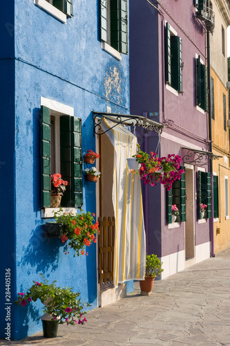 Venice, Burano. A row of colorful homes along the canal.