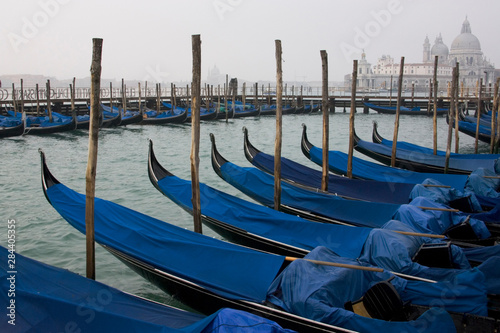 Italy, Venice. Moored gondolas with Santa Maria della Salute in background. © Jaynes Gallery/Danita Delimont