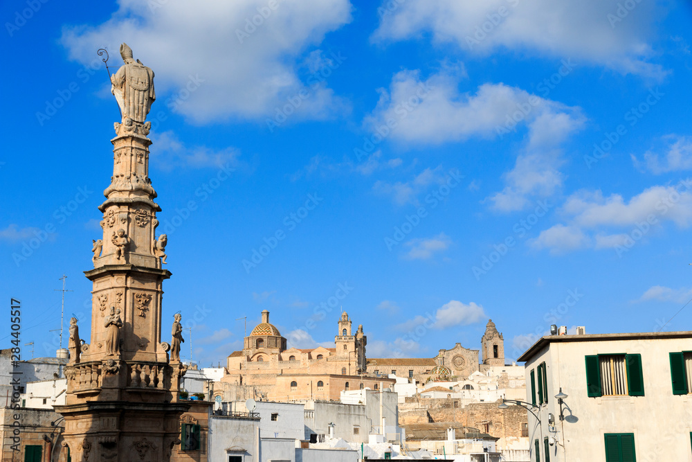 Italy, Ostuni. Statue of Saint Oronzo looks down on the square of Italian town of Ostuni which is known as the 'White City' in Italy.