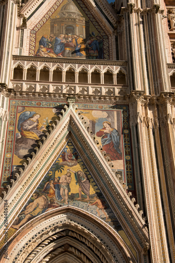 Italy, Umbria, Orvieto. The Cathedral of Orvieto or Duomo of Orvieto. 13th century Gothic masterpiece, one of the best Gothic buildings in Italy. Detail of facade with religious mosaic..