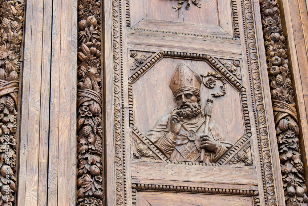 Italy, Florence. Carved wooden doors of Basilica di Santa Croce detail