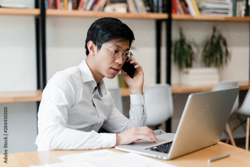 asian businessman in the office works with laptop asian businessman in the office works with laptop