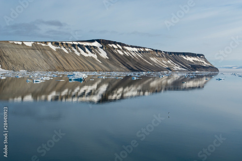 Norway, Barents Sea, Svalbard, Nordaustlandet. Palanderbukta (Palander Bay). Calm fjord reflections.