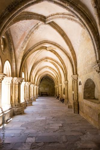 Portugal  Coimbra. Old Cathedral cloister. Archways  walking paths  courtyard.