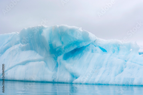 Norway. Svalbard. Nordaustlandet Island. Brasvelbreen. Turquoise ice bergs in the calm water.