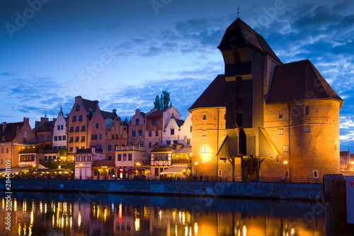 Poland, Gdansk. Buildings reflect in port water at sunset. Credit as: Jim Zuckerman / Jaynes Gallery / DanitaDelimont.com