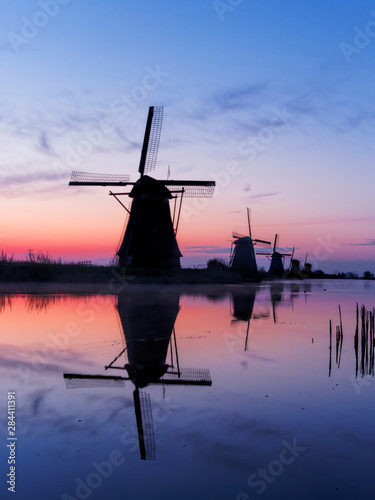 Netherlands, Kinderdijk, Windmills at Sunrise along the canals of Kinderdijk