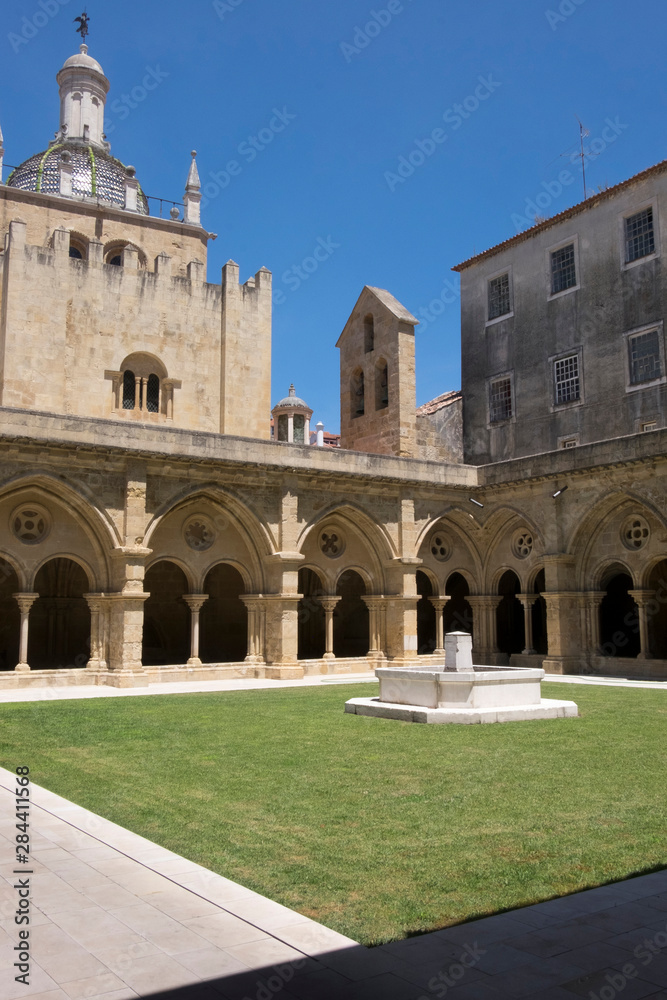 Portugal, Coimbra. Old Cathedral cloister. Archways, walking paths, courtyard.