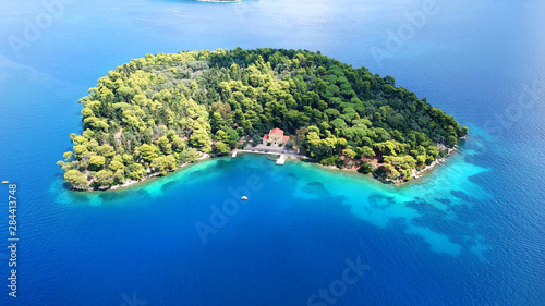 Aerial drone photo of iconic uninhabited island of Madouri in bay of Nydri and Mansion of 19th-century poet Aristotelis Valaoritis, Lefkada, Ionian, Greece photo