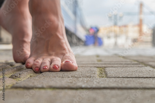 barefoot girl at the train station